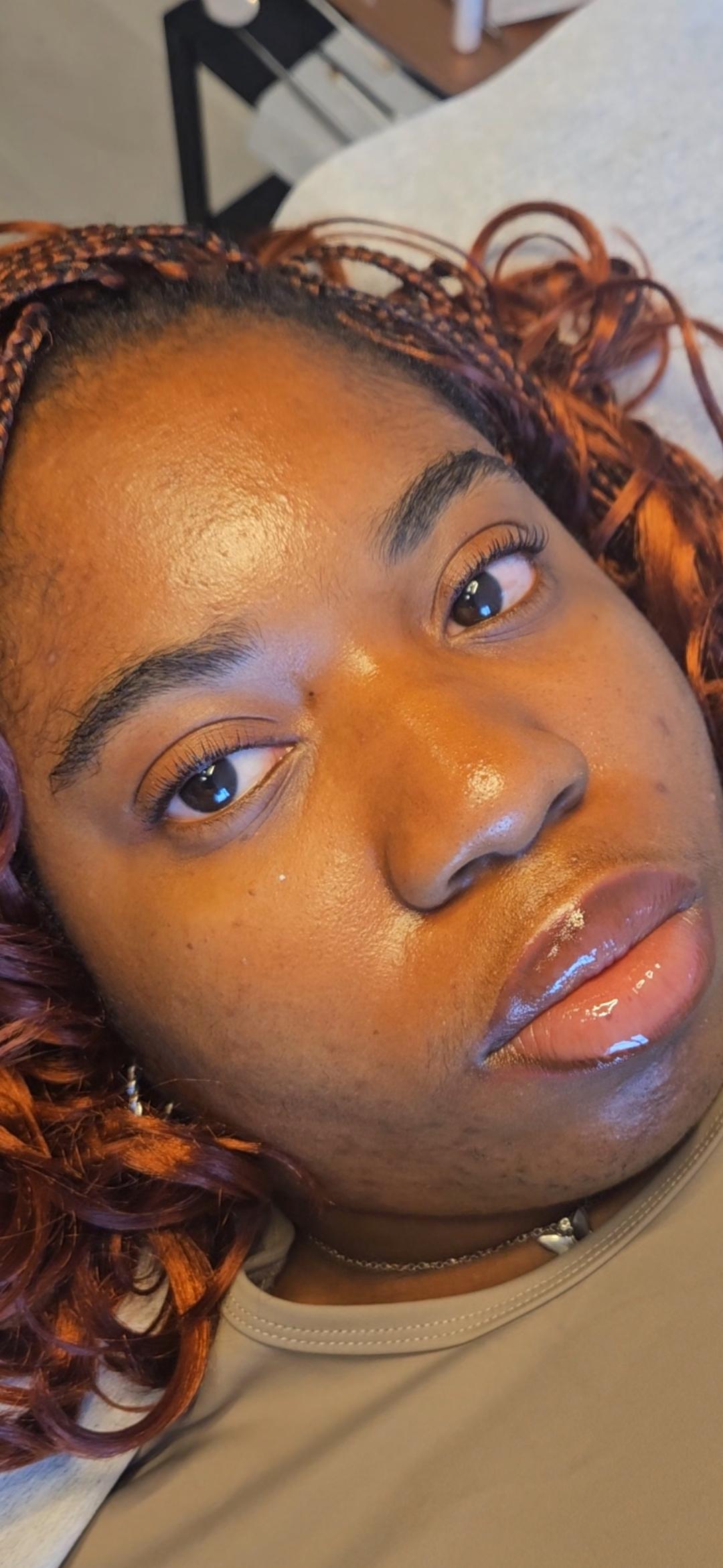 Happy client showing off her new lash extensions